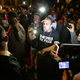 Bassem Masri, center, a man who has live streamed many of the protests in Ferguson, Mo., confronts a St. Louis police officer at the intersection of Shaw Boulevard and Klemm Street as protesters gather at the scene of a fatal police officer-involved shooting on Wednesday, Oct. 8, 2014.